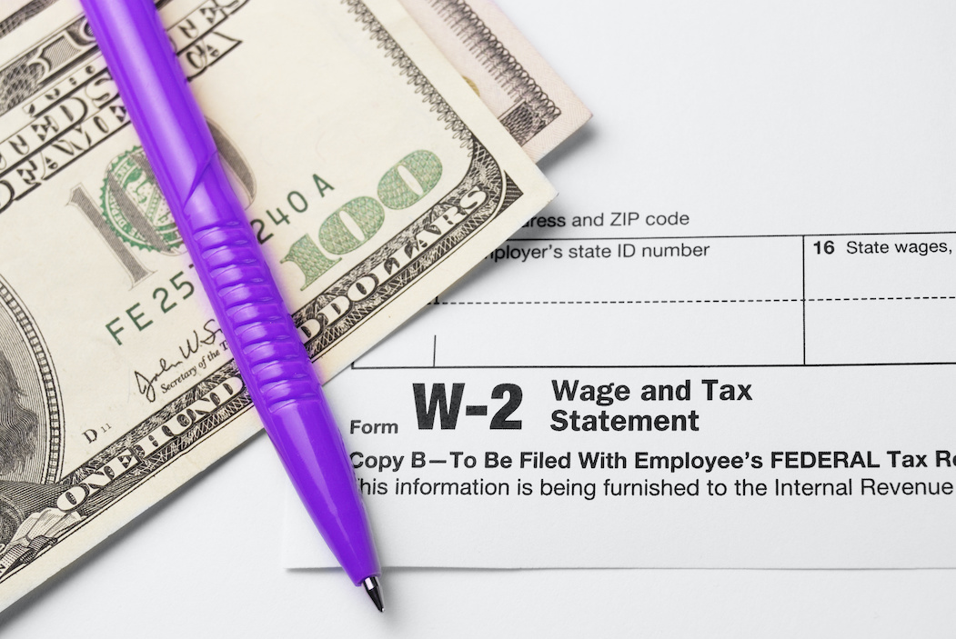 W-2 forms, purple pen, and $100 bill | CTR Payroll Pittsubrgh